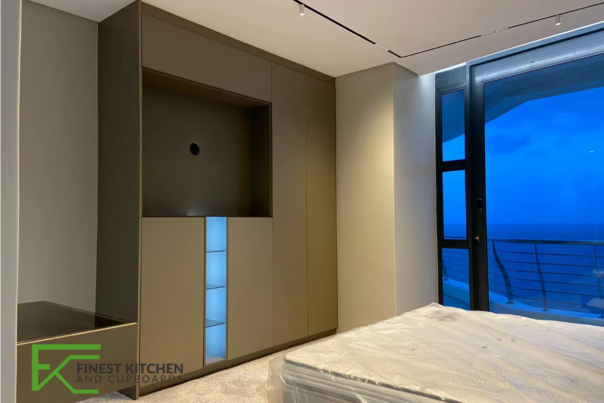 A dark timber-panelled FKC wall unit running alongside a full-height window.