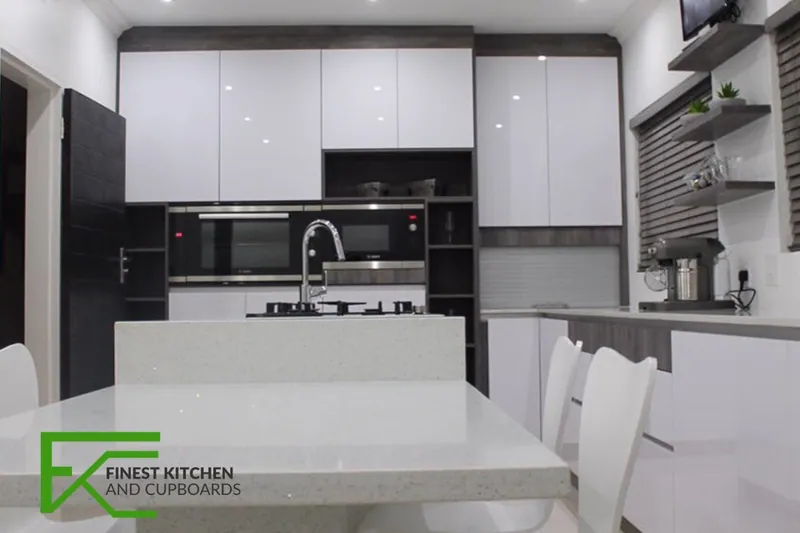 A gloss-white FKC kitchen with a stone-topped island, installed in a Vereeniging home.