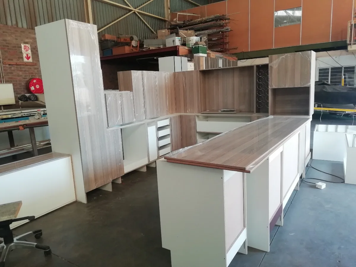 Assembled cabinet carcasses standing in the FKC Kitchens workshop, checked before delivery to site.